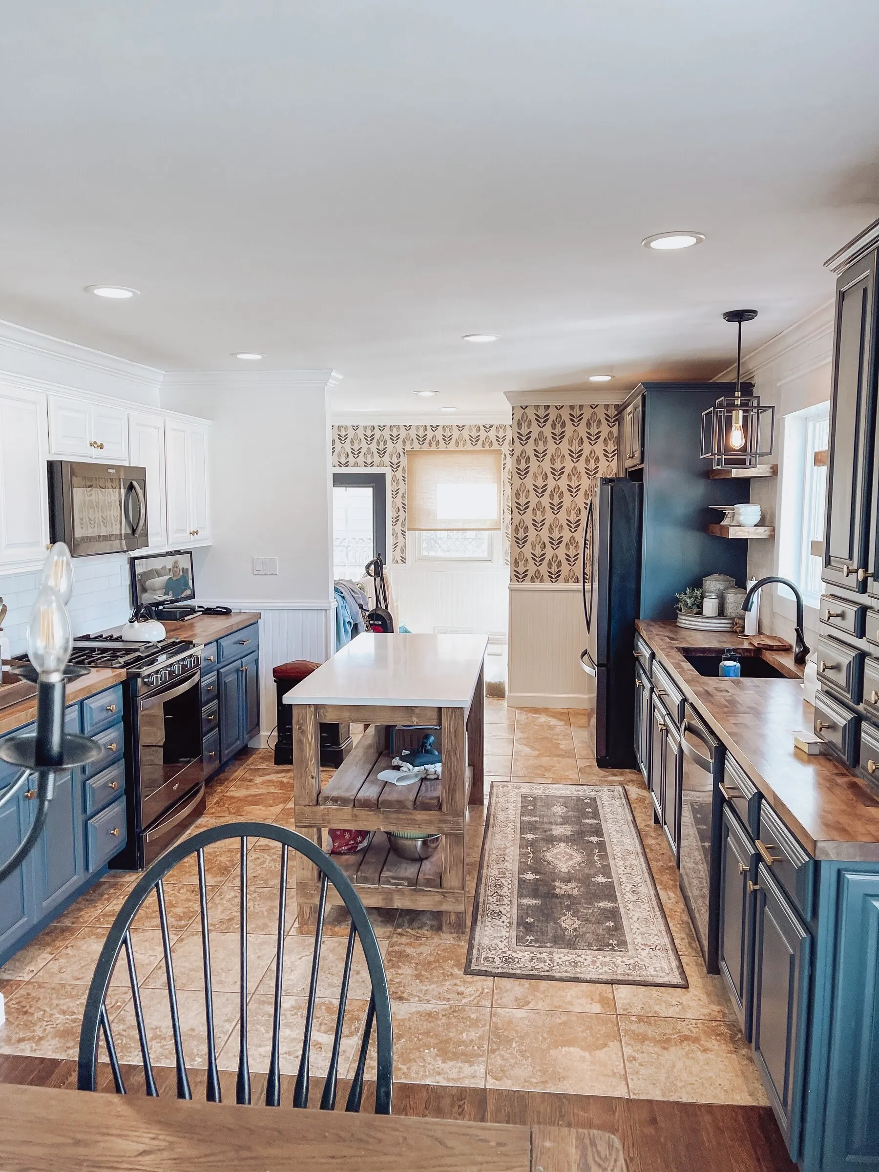 Under-cabinet and pendant lighting in a blue-cabinet kitchen